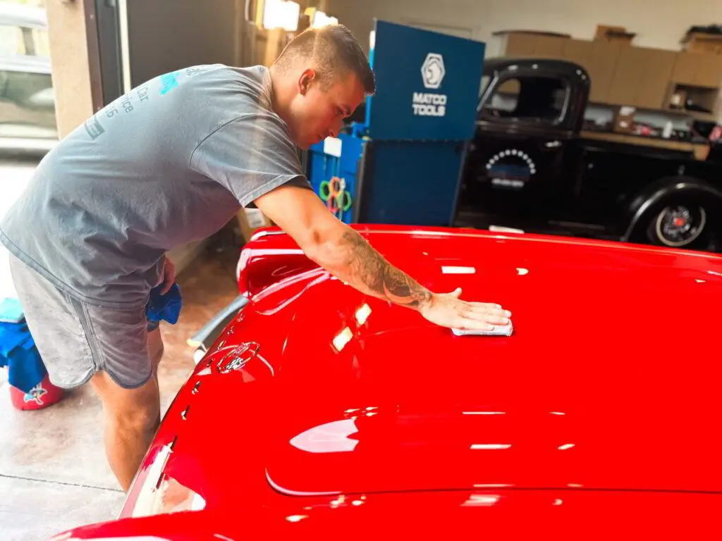 applying ceramic coating red car hood daniel's detailing mesa az