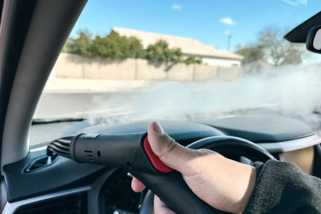 Person using a steam cleaner to defog a car windshield | Interior car detailing | Daniel's Detailing