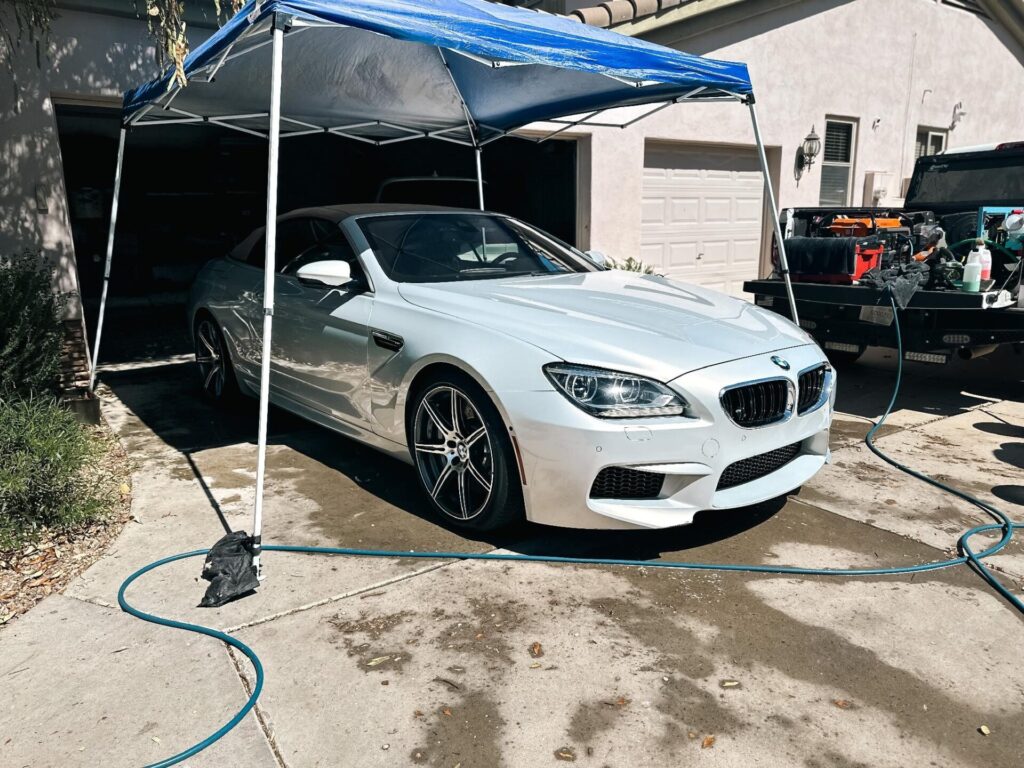 Silver BMW convertible under mobile detailing canopy | Daniel’s Detailing